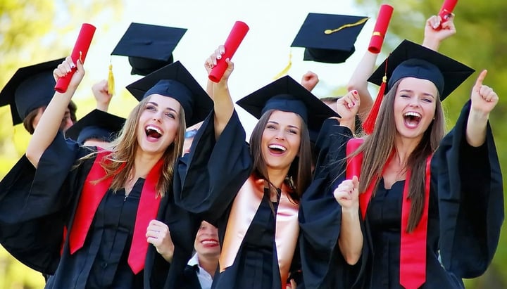 A group of college graduates in caps and gowns