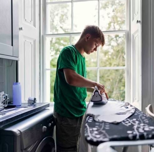 Person ironing clothing at home