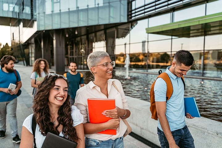 Group of friends walking with notebooks