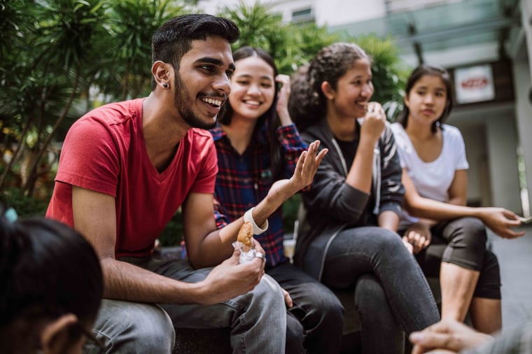 Friends sitting around laughing
