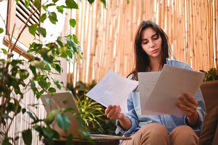 Person reviewing papers focusing outside