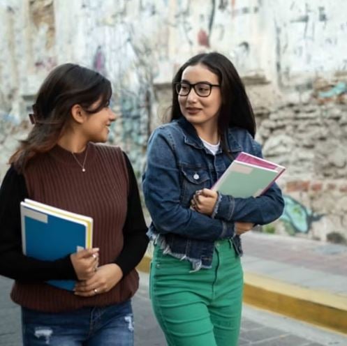 two friends walking down the street talking
