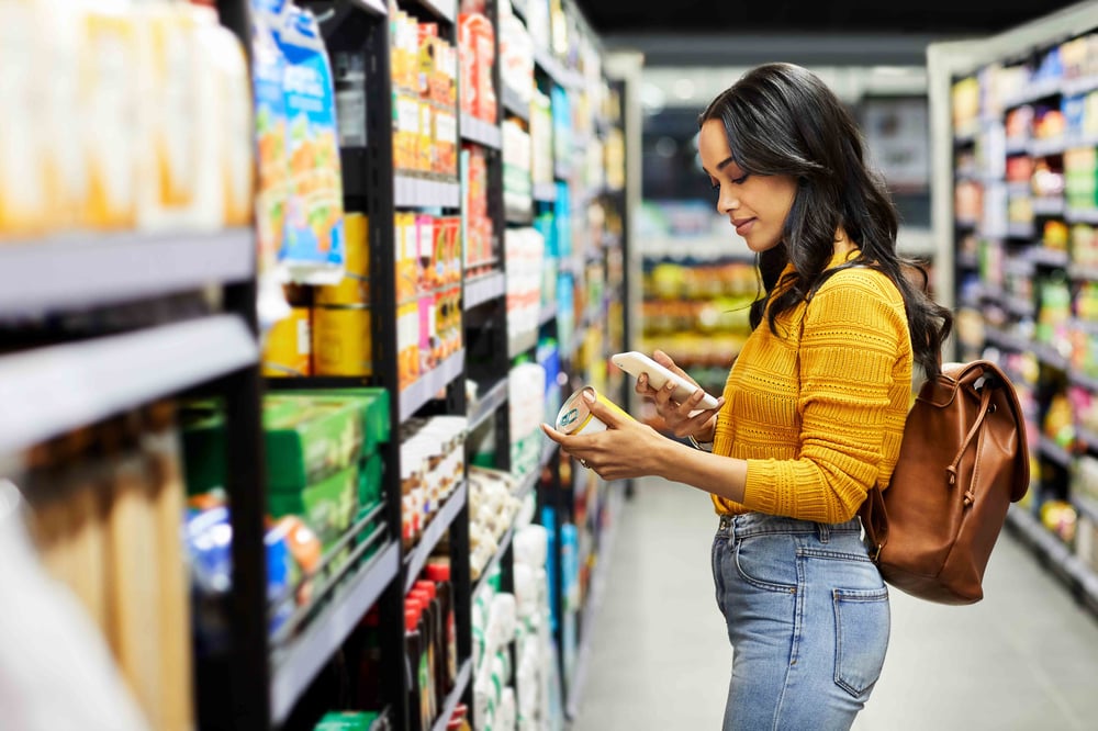 Person food shopping and looking at prices